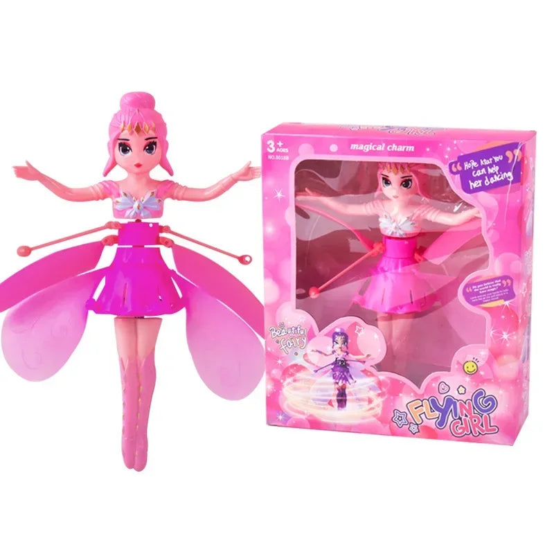 Pink fairy doll with butterfly wings and packaging on a white background